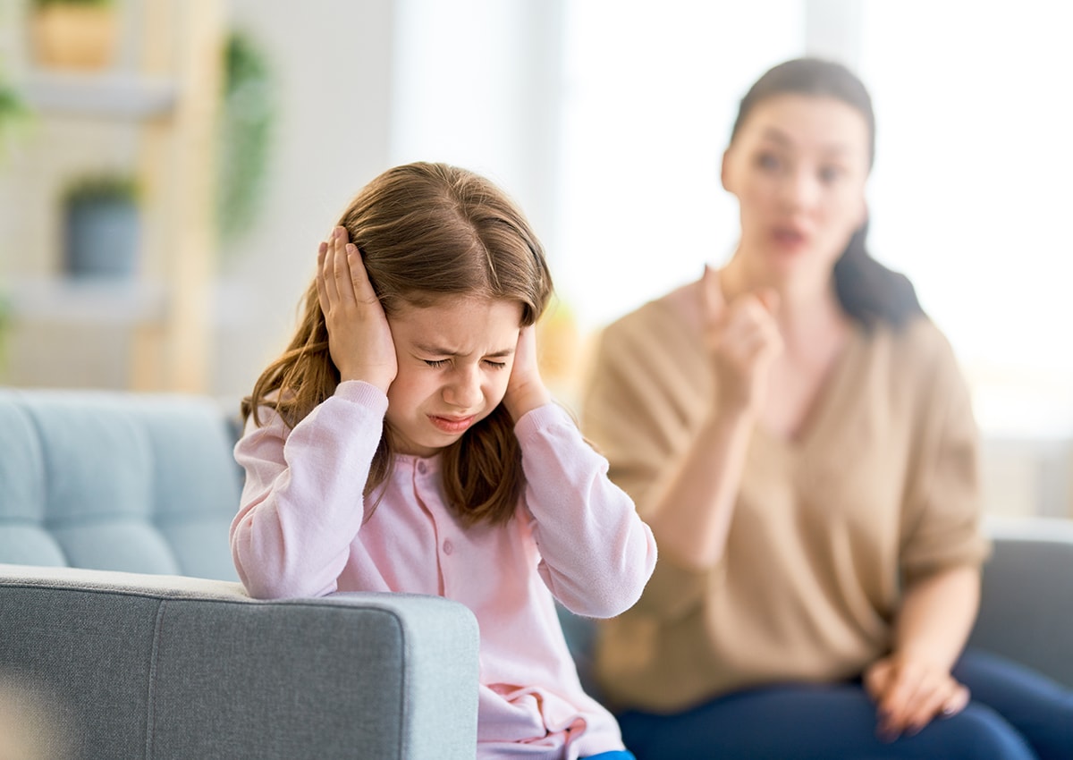 Anxious girl being scolded by mother