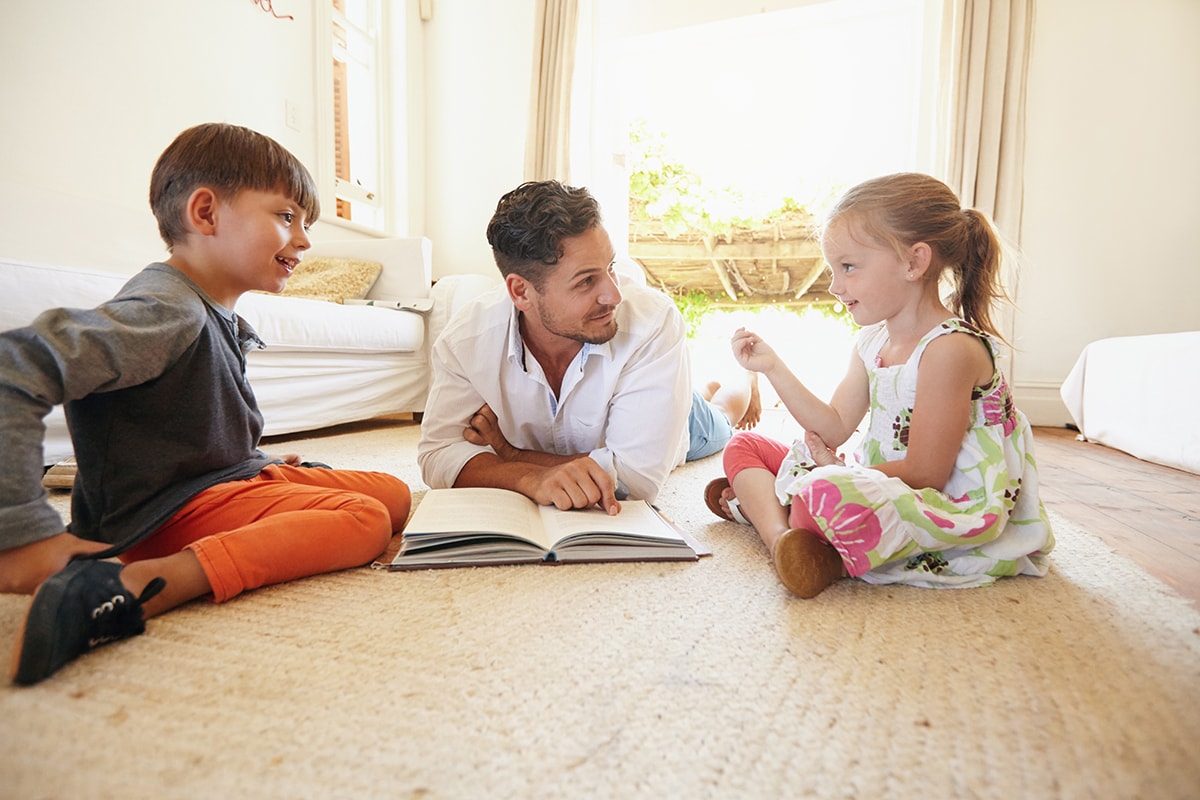 Father reading to two kids