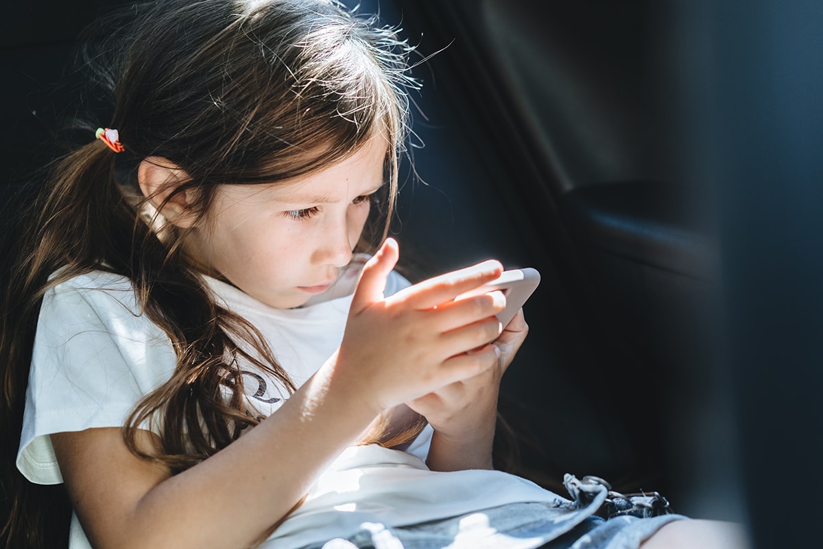 Girl using smartphone in car