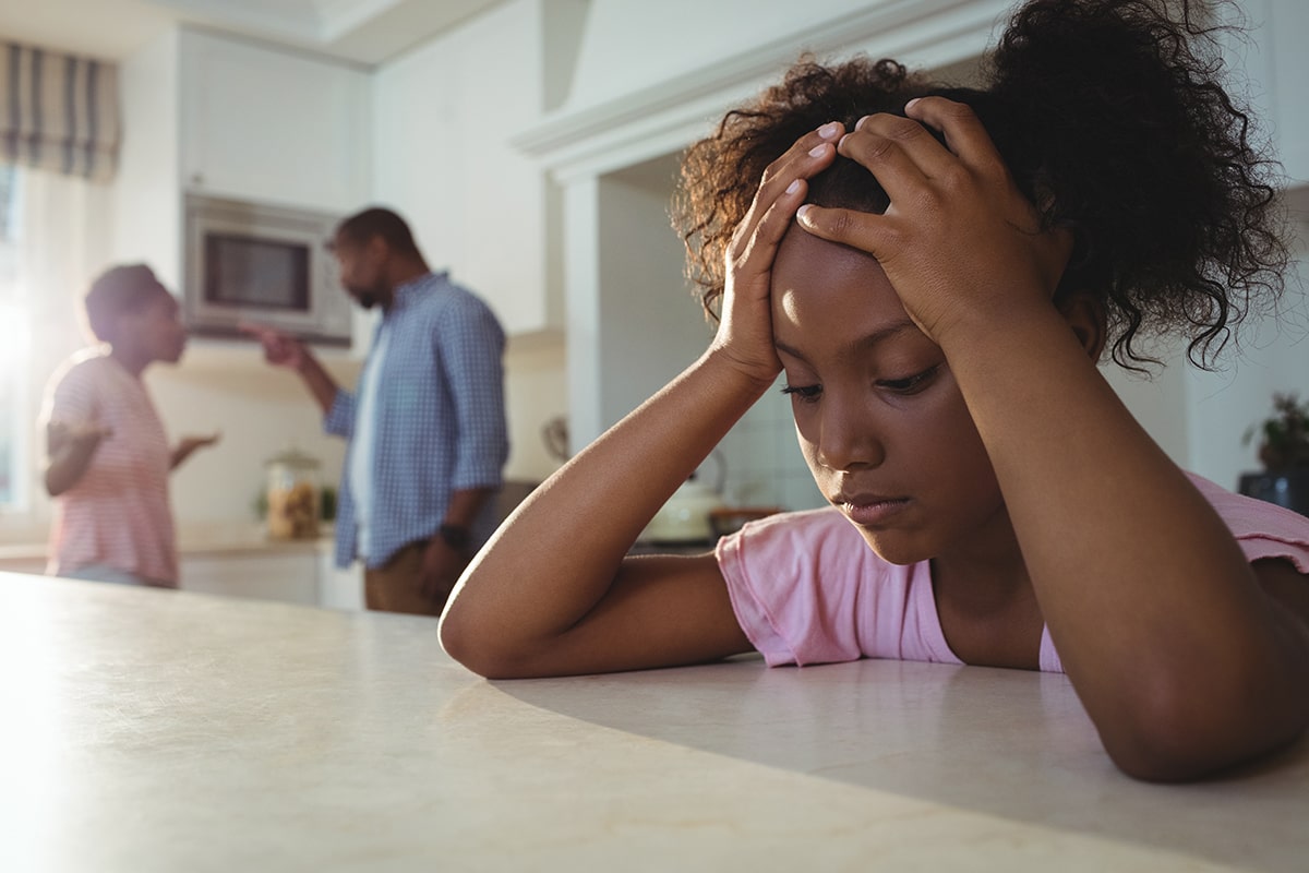 Parents arguing in front of anxious child