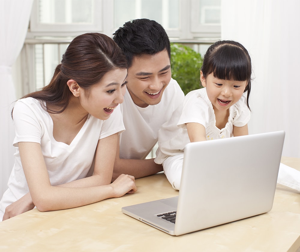 Happy family looking at laptop